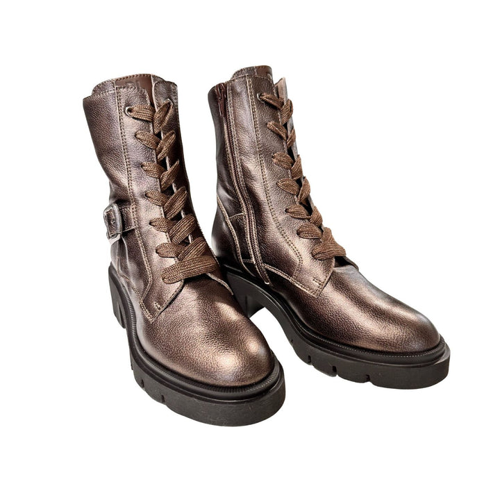 Pair of brown leather boots with laces on a white background