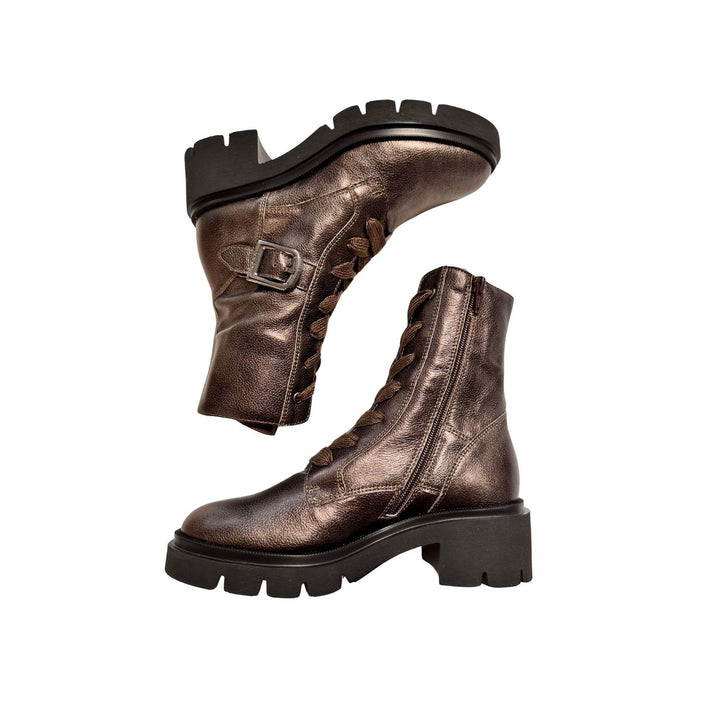 Pair of bronze leather boots with black soles on a white background