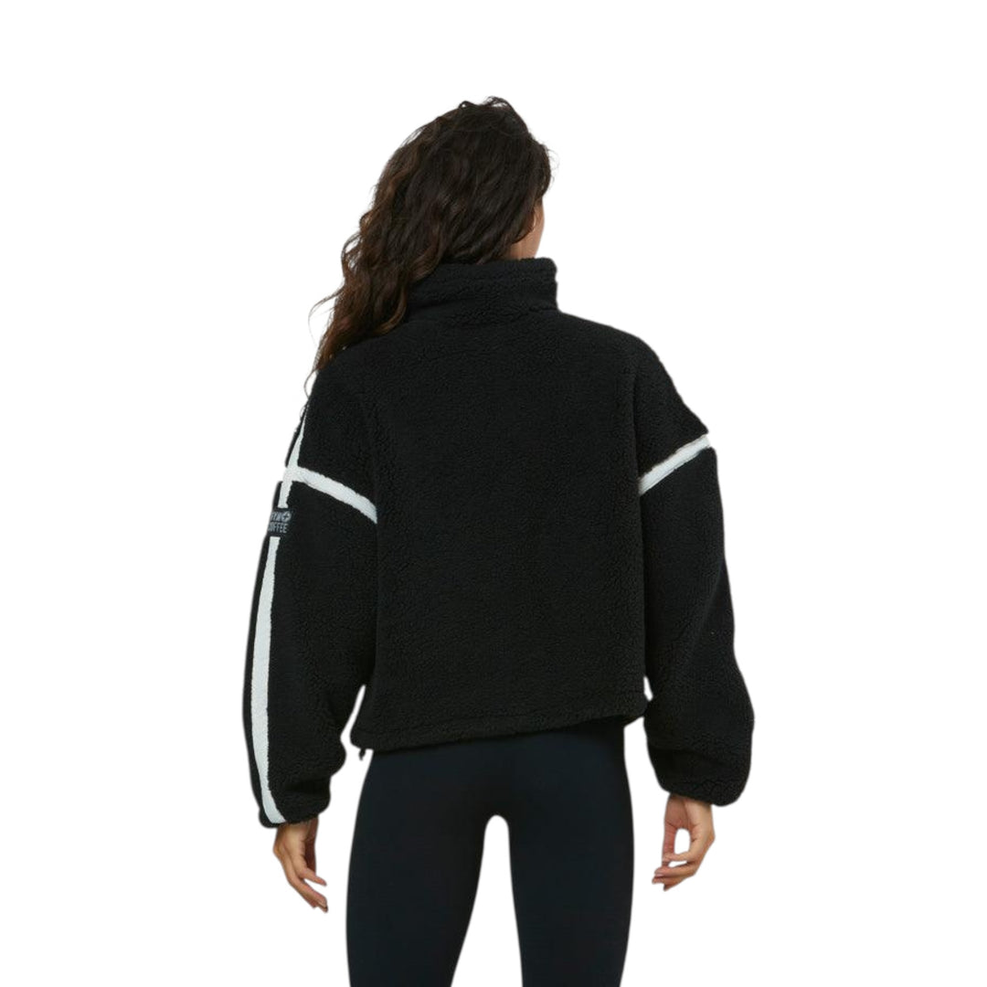 Person wearing a black jacket with white stripes on a white background