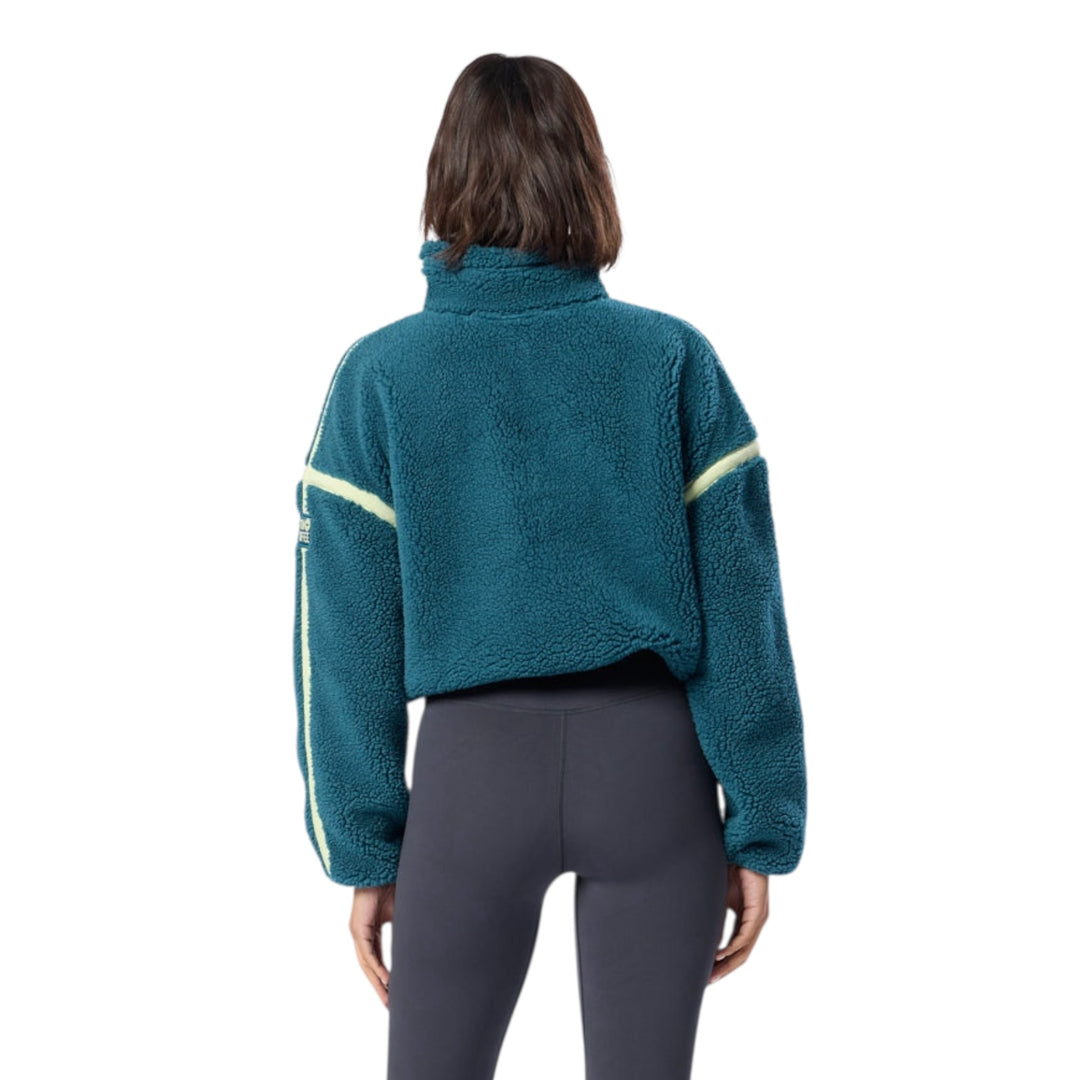 Back view of woman in teal fleece sweatshirt with lime trim.