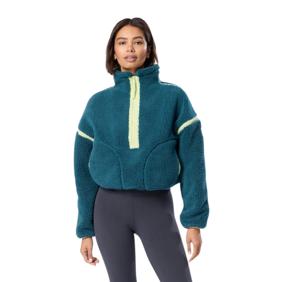 Woman in teal fleece sweatshirt with lime trim.
