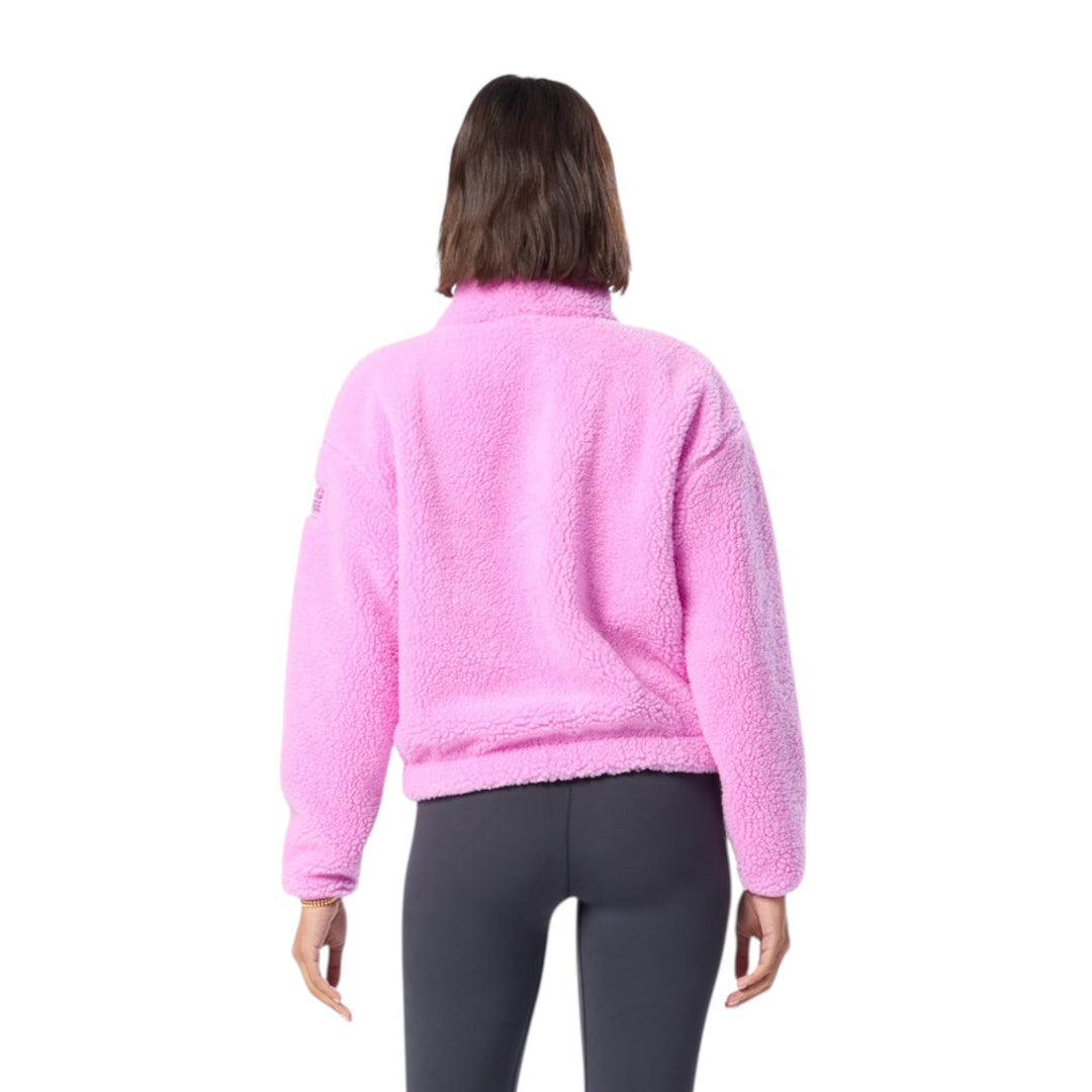 Woman wearing a pink fleece jacket on a white background