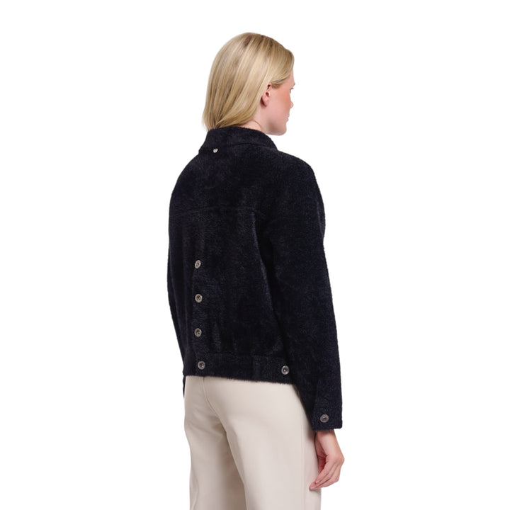 Woman wearing a dark blue jacket on a white background