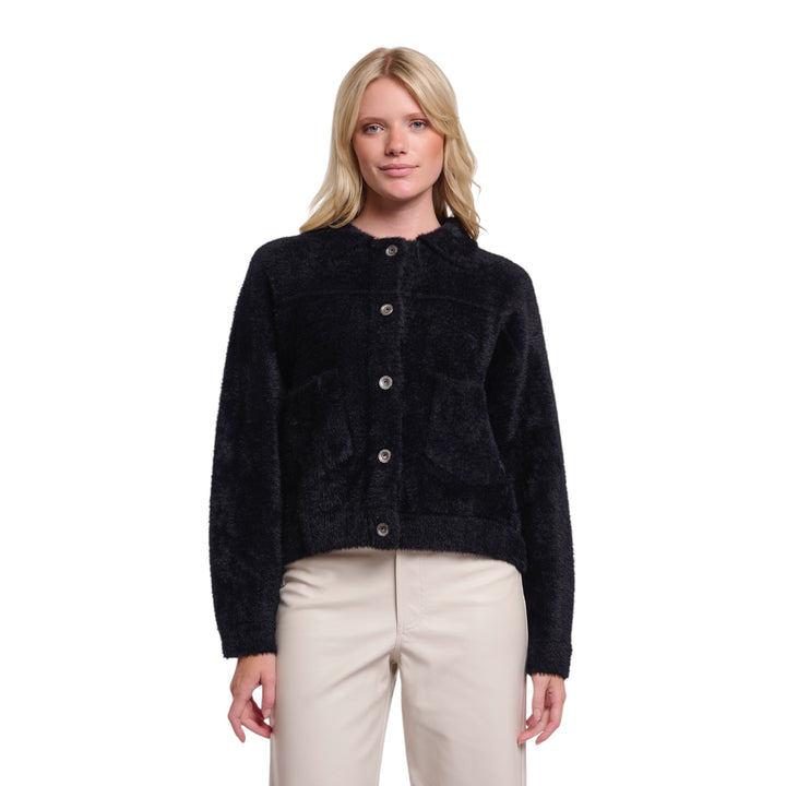 Woman wearing a black jacket with button details on a white background