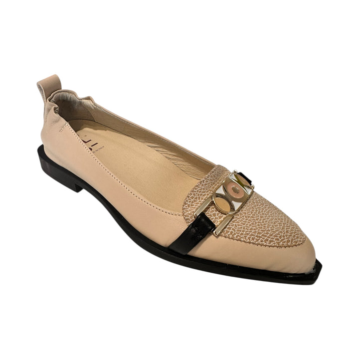 Beige flat shoe with a black sole on a white background