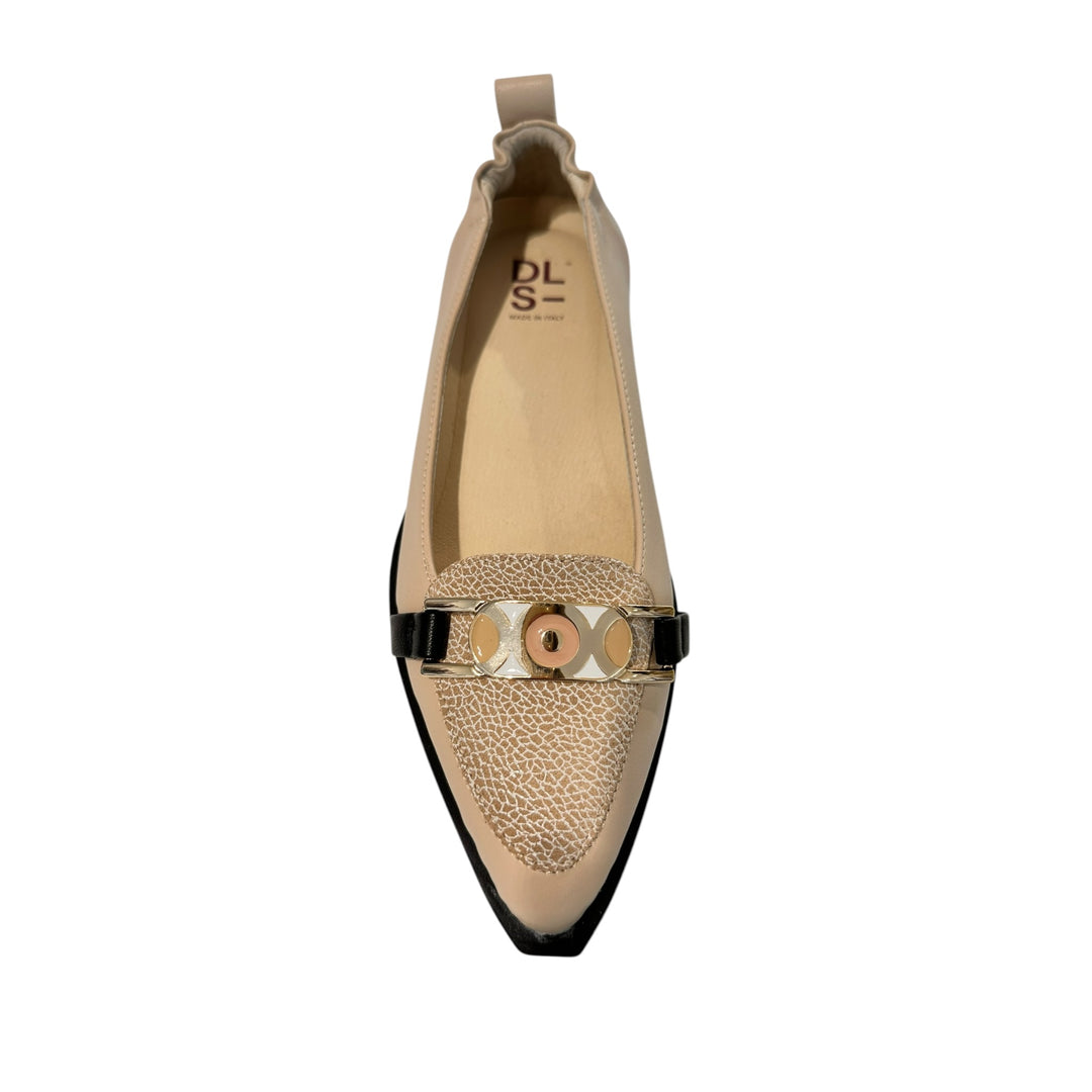 Beige flat shoe with decorative strap on a white background