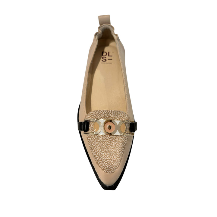 Beige flat shoe with decorative strap on a white background