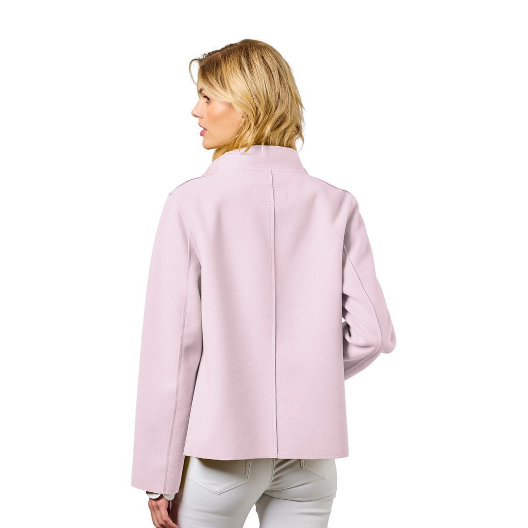 Woman wearing a light pink coat on a white background
