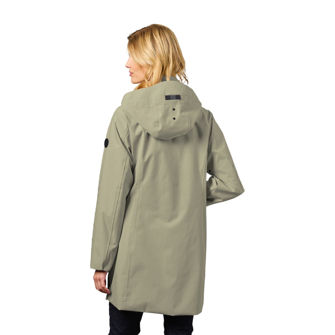 Woman wearing a green raincoat on a white background