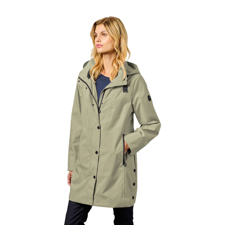 Woman wearing a light green raincoat on a white background