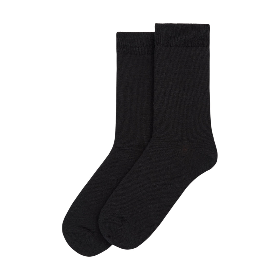 Pair of black merino wool socks on a white background
