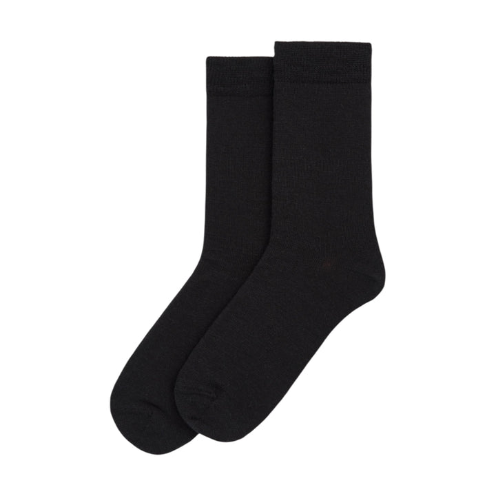 Pair of black merino wool socks on a white background