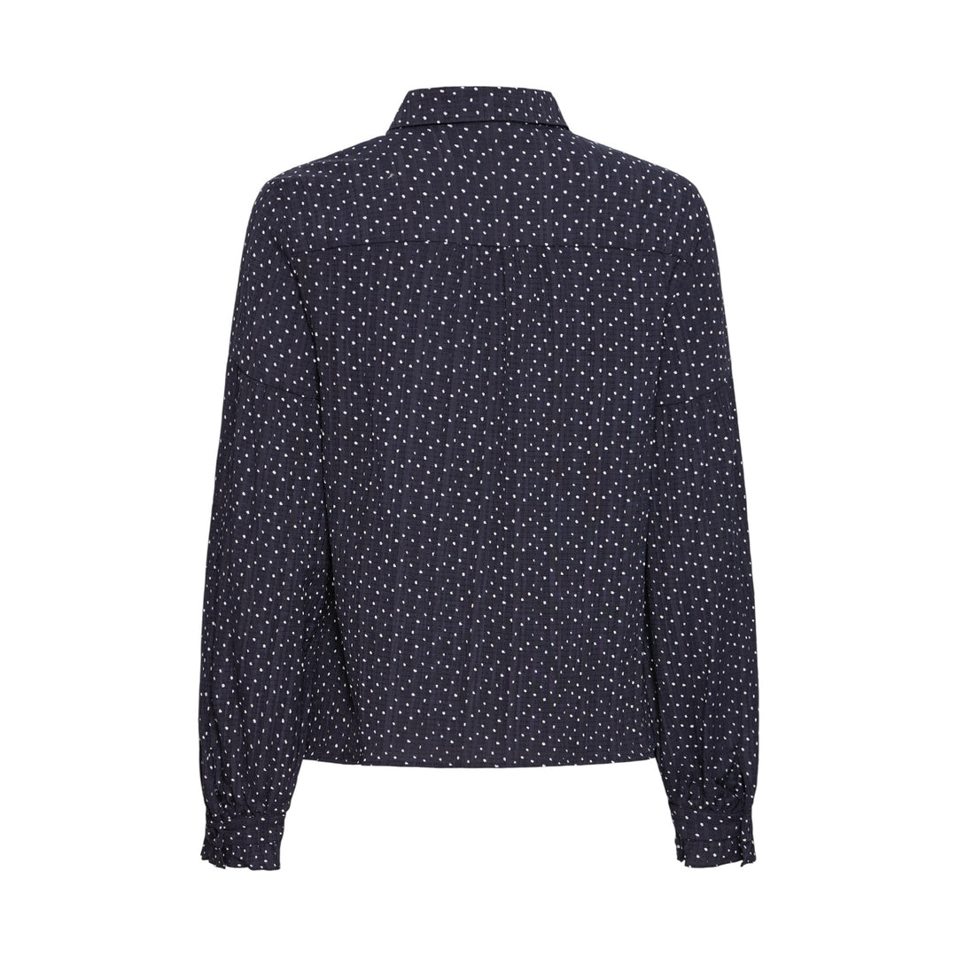 Navy blue blouse with white polka dot pattern on a white background