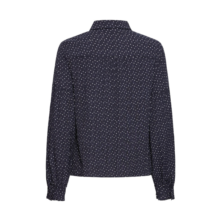 Navy blue blouse with white polka dot pattern on a white background