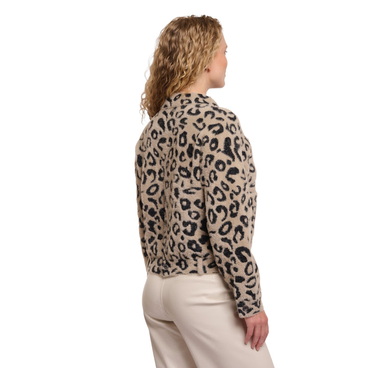 Woman wearing a leopard print long-sleeve top on a white background